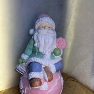 Cute Santa Sitting on a Christmas Ball